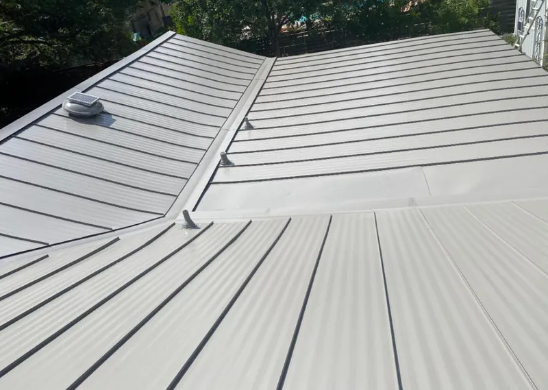 Solar attic fan installed on a metal roof for Roof Ventilation in Summerville